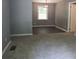 Cozy living room with gray walls, plush carpeting, and a decorative light fixture at 3086 Lone Oak Sw Ave, Atlanta, GA 30354
