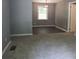 Inviting living area featuring neutral carpet and a glimpse of a dining space with hardwood floors at 3086 Lone Oak Sw Ave, Atlanta, GA 30354