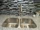 Close up view of a stainless steel kitchen sink with a granite countertop and mosaic tile backsplash at 3086 Lone Oak Sw Ave, Atlanta, GA 30354