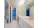 Bright bathroom with double vanity, large mirror and with an open door to the toilet at 3195 Vickery Dr, Marietta, GA 30066