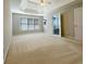 Spacious bedroom with a tray ceiling, fan, and doors to the bathroom at 3195 Vickery Dr, Marietta, GA 30066