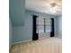 Calm blue bedroom featuring a window for natural light, patterned carpet, and a ceiling fan at 3195 Vickery Dr, Marietta, GA 30066