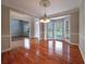 Bright dining room featuring hardwood floors, large bay window, and elegant chandelier at 3195 Vickery Dr, Marietta, GA 30066