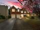 Two-story red brick home with a well-manicured lawn and a two-car garage at 3195 Vickery Dr, Marietta, GA 30066