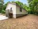 Home back exterior featuring green trees, a wooden deck, and lawn at 355 Marietta Hwy, Roswell, GA 30075