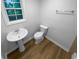 Compact bathroom featuring a pedestal sink and toilet, complemented by neutral walls at 355 Marietta Hwy, Roswell, GA 30075