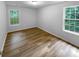 A well-lit bedroom featuring natural light and wood-look flooring at 355 Marietta Hwy, Roswell, GA 30075