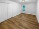 Bedroom with hardwood floors, walk-in closet, and a large window allowing lots of natural light at 355 Marietta Hwy, Roswell, GA 30075