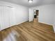 Bright bedroom with closet and doorway to a full bathroom, complete with wood flooring at 355 Marietta Hwy, Roswell, GA 30075