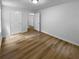 Bedroom with wood flooring, white trim, and a closet, offering ample space at 355 Marietta Hwy, Roswell, GA 30075