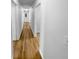 Bright hallway featuring wood flooring and white walls, leading to various rooms in the home at 355 Marietta Hwy, Roswell, GA 30075