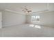 This spacious carpeted bedroom has 2 windows and a ceiling fan at 124 Felicity Pike, Locust Grove, GA 30248