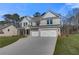 Newly built two-story home with a three-car garage and front lawn at 124 Felicity Pike, Locust Grove, GA 30248