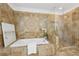 Bathroom featuring tilework, a bathtub, and a glass door shower at 230 Summerhouse Ln, Atlanta, GA 30350