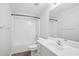 Bright bathroom featuring a tub shower, white vanity, and large mirror at 230 Summerhouse Ln, Atlanta, GA 30350