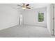 Well-lit bedroom with carpet, ceiling fan, a view to outside, and a full-length mirror at 230 Summerhouse Ln, Atlanta, GA 30350