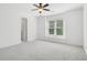 Large, empty bedroom with a ceiling fan, and a window bench at 230 Summerhouse Ln, Atlanta, GA 30350