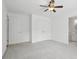Bedroom featuring carpet, a ceiling fan, large closets, and an ensuite bathroom at 230 Summerhouse Ln, Atlanta, GA 30350