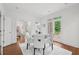 Bright dining area with white chairs and a round table, perfect for enjoying meals with Gathering and friends at 230 Summerhouse Ln, Atlanta, GA 30350