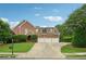 Traditional brick home with a three-car garage and well-manicured lawn at 230 Summerhouse Ln, Atlanta, GA 30350