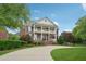 Stately brick home featuring a double front porch and mature landscaping at 230 Summerhouse Ln, Atlanta, GA 30350