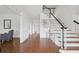 Inviting foyer with hardwood floors, staircase, and modern decor, creating a grand entrance to the home at 230 Summerhouse Ln, Atlanta, GA 30350