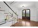 Elegant foyer with hardwood floors and a beautiful dark front door and staircase at 230 Summerhouse Ln, Atlanta, GA 30350