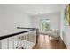 Upstairs hallway leading to an outdoor balcony with a seating area, offering a relaxing retreat at 230 Summerhouse Ln, Atlanta, GA 30350
