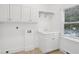 Functional laundry room with cabinets and sink, offering convenience and organization for household chores at 230 Summerhouse Ln, Atlanta, GA 30350