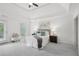 Spacious main bedroom with a tray ceiling, light carpet, and a private balcony, creating a serene escape at 230 Summerhouse Ln, Atlanta, GA 30350