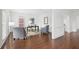 Bright home office with hardwood floors, a dark desk, and stylish furniture creating a comfortable workspace at 230 Summerhouse Ln, Atlanta, GA 30350
