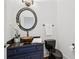 Elegant powder room featuring dark blue vanity, ornate mirror, and modern fixtures, providing a stylish space at 230 Summerhouse Ln, Atlanta, GA 30350