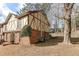 The townhouse with brick and Tudor details has a small backyard and mature trees at 3252 Abbeywood Dr, Decatur, GA 30034