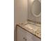 A renovated bathroom featuring white vanity with granite countertop and updated mirror at 3252 Abbeywood Dr, Decatur, GA 30034