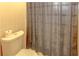 Close up of toilet with gray shower curtain in a bathroom with yellow tile at 3252 Abbeywood Dr, Decatur, GA 30034