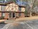 A brick townhome featuring a Tudor-style facade with decorative timber accents and mature trees at 3252 Abbeywood Dr, Decatur, GA 30034