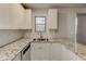 Bright kitchen with white cabinets, granite countertops, stainless steel sink, and a window at 3252 Abbeywood Dr, Decatur, GA 30034
