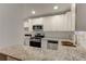 Open concept kitchen with granite countertops, stainless steel appliances, and bright white cabinetry at 3252 Abbeywood Dr, Decatur, GA 30034