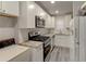 Modern kitchen featuring white cabinets, granite countertops, and stainless steel appliances at 3252 Abbeywood Dr, Decatur, GA 30034