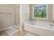 Clean bathroom showcasing a white tub and a glass-door shower at 4889 Arbor View Nw Pkwy, Acworth, GA 30101