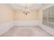 Dining room featuring chair-rail detail, carpet, and modern chandelier at 4889 Arbor View Nw Pkwy, Acworth, GA 30101