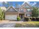 Charming two-story brick home with a well-maintained lawn and attached two-car garage at 4889 Arbor View Nw Pkwy, Acworth, GA 30101