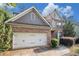 Lovely brick home with a two-car garage, manicured bushes, and a well-kept lawn at 4889 Arbor View Nw Pkwy, Acworth, GA 30101