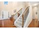 Bright, inviting foyer with hardwood floors, a staircase, and a view to the front door at 4889 Arbor View Nw Pkwy, Acworth, GA 30101