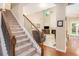 Staircase leading into a living room with a fireplace and view of backyard at 4889 Arbor View Nw Pkwy, Acworth, GA 30101