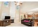 Open-concept living room with a fireplace, high ceiling, and views of the kitchen at 4889 Arbor View Nw Pkwy, Acworth, GA 30101
