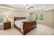 Main bedroom with tray ceiling, ceiling fan, and neutral carpet at 4889 Arbor View Nw Pkwy, Acworth, GA 30101