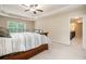 Spacious main bedroom featuring a ceiling fan, tray ceiling, and a large window offering natural light at 4889 Arbor View Nw Pkwy, Acworth, GA 30101