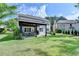 Spacious backyard with a covered patio, lush green lawn, and mature trees, perfect for outdoor living at 9440 Knollcrest Blvd, Alpharetta, GA 30022