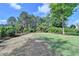 Lush backyard featuring manicured landscaping, mature trees, and a well-maintained lawn with thriving plant beds at 9440 Knollcrest Blvd, Alpharetta, GA 30022